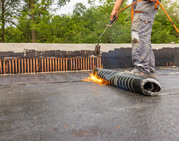 Bituminous membrane waterproofing system details and installation on flat rooftop.